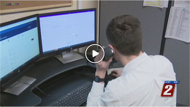  Ian Basinger - Family Tech Support specialist, at his desk answering a call